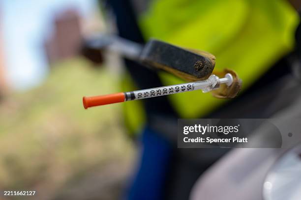 Outreach workers with St. Ann’s Corner of Harm Reduction participate in a weekly needle clean-up at a Bronx park that drug users often use on April...
