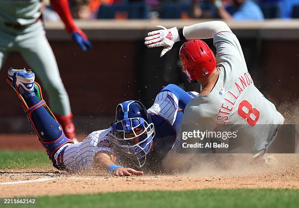 Nick Castellanos of the Philadelphia Phillies is tagged out at home by Hayden Senger of the New York Mets during their game at Citi Field on April...