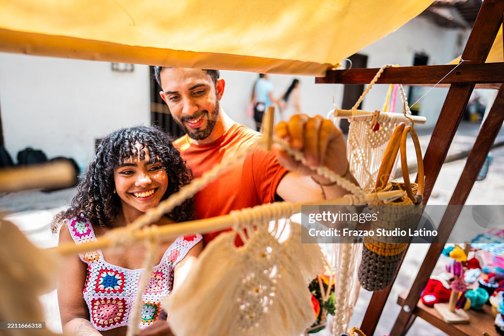 Couple looking at souvenirs on a street market in historic district of Bucaramanga, Colombia