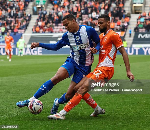 Blackpool's CJ Hamilton cross is blocked by Wigan Athletic's Toby Sibbick during the Sky Bet League One match between Wigan Athletic FC and Blackpool...