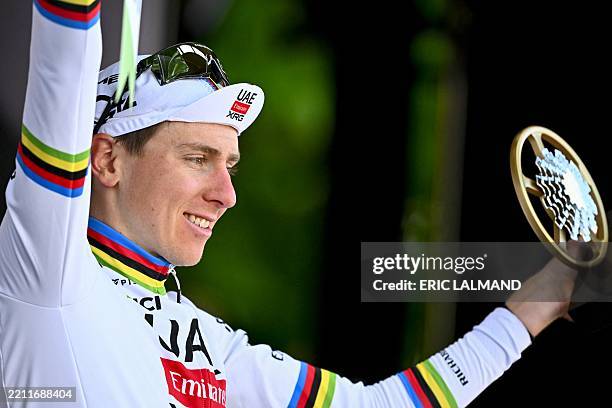 Team Emirates' Slovenian rider Tadej Pogacar celebrates with his trophy on the podium after winning the Liege-Bastogne-Liege one day cycling race,...