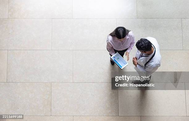 medical insurance agent talking to a doctor at the hospital - medical sales representative stock pictures, royalty-free photos & images