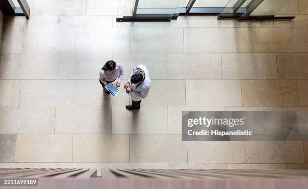 medical insurance agent asking a doctor to fill a form at the hospital - medical sales representative stock pictures, royalty-free photos & images