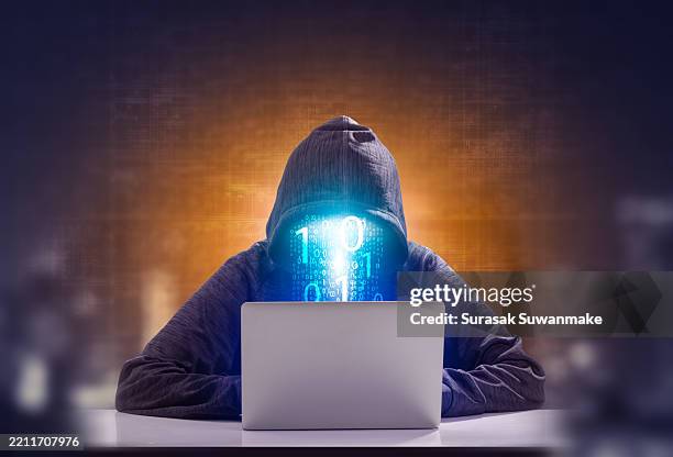 faceless hackers and malware hackers use laptops with dangerous digital code on binary code background. - cyborg stock pictures, royalty-free photos & images