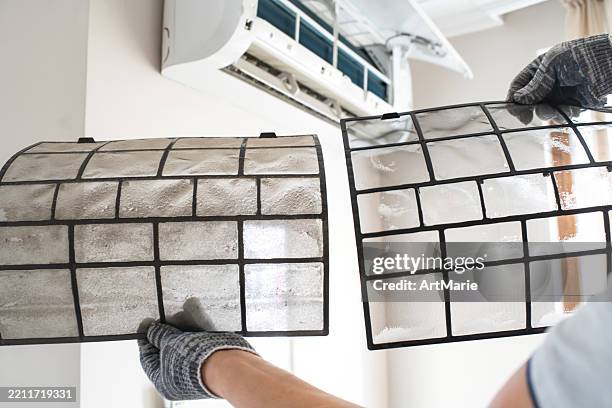 technician with dirty and clean filters of air conditioner indoors - filtration stock pictures, royalty-free photos & images