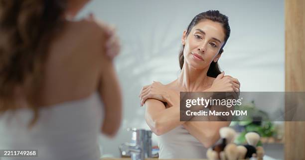 beauty, mirror and skincare with woman in bathroom of home for hygiene, relax or wellness. antiaging, body and reflection or mature person in apartment for dermatology or moisturizing routine - dermatology stock pictures, royalty-free photos & images