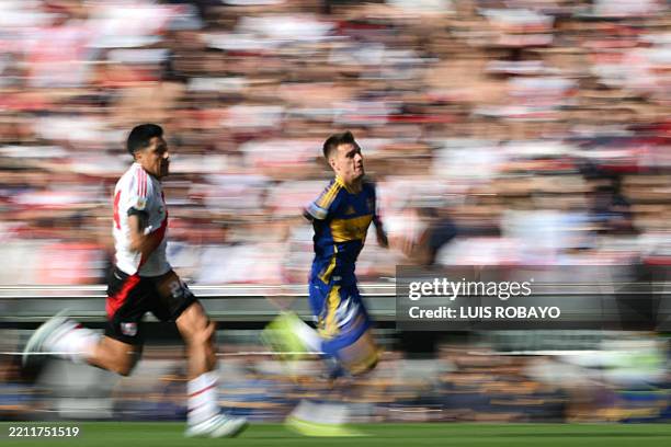 River Plate's midfielder Enzo Perez and Boca Juniors' midfielder Kevin Zenon fight for the ball during the Argentine Professional Football League...