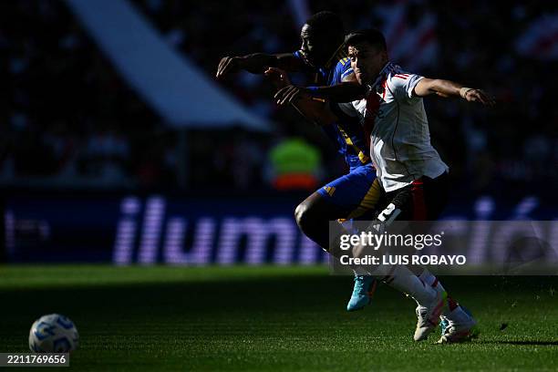 Boca Juniors' Peruvian defender Luis Advincula and River Plate's defender Marcos Acuna fight for the ball during the Argentine Professional Football...