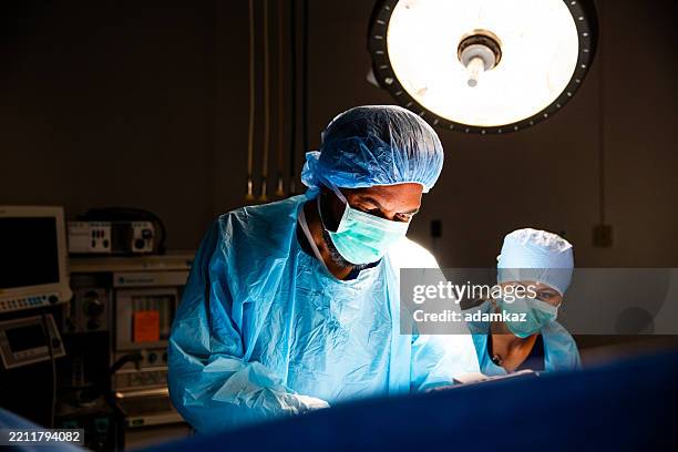 black surgeon in operating room - newborn heart surgery stock pictures, royalty-free photos & images