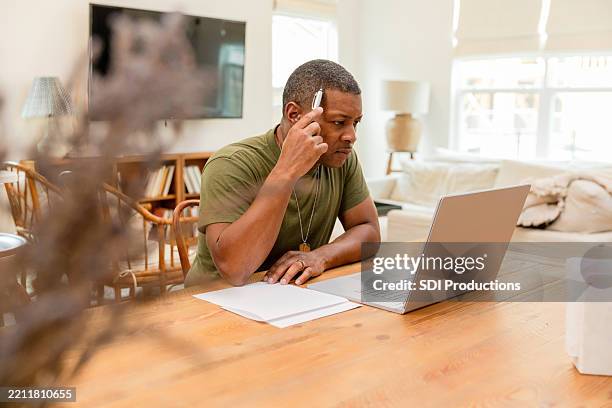 military man working from home on laptop - post traumatic stress disorder stock pictures, royalty-free photos & images