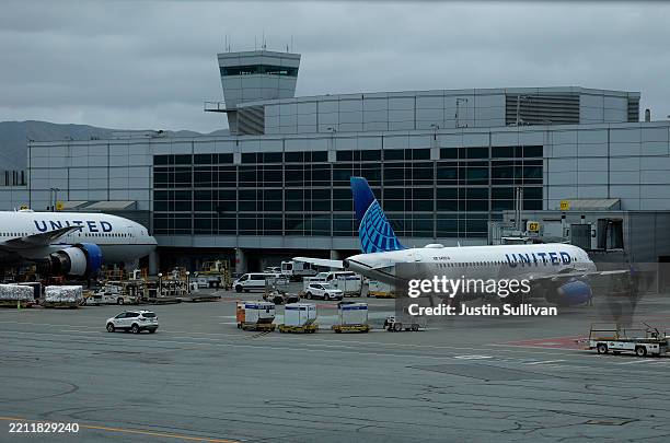 United Airlines planes sit parked at the ga at San Francisco International Airport on April 24, 2025 in San Francisco, California. Southwest and...