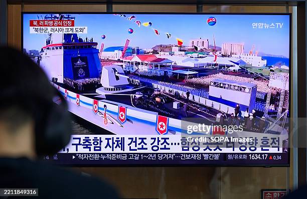 People look at a 24-hour Yonhap news TV broadcast at Seoul Railway Station showing a news broadcast with North Korea's new destroyer Choi Hyun at a...