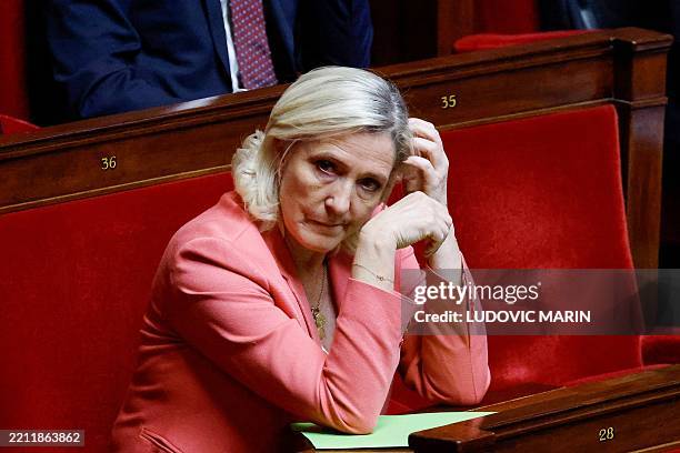 Leader of the far-rigth Rassemblement National parliamentary group Marine Le Pen reacts as she attends a government statement and parliamentary...