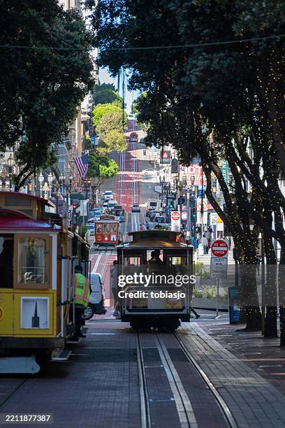 san francisco cable cars on powell and market street - market street san francisco stockfoto's en -beelden