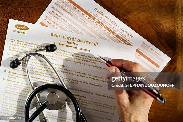 Woman fills out a care and sick leave form in Saint Ouen sur Seine in the Seine Saint Denis department in France on April 23, 2025.