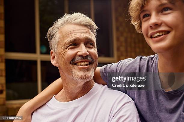happy father and son smiling together in australian backyard - dad son stock pictures, royalty-free photos & images