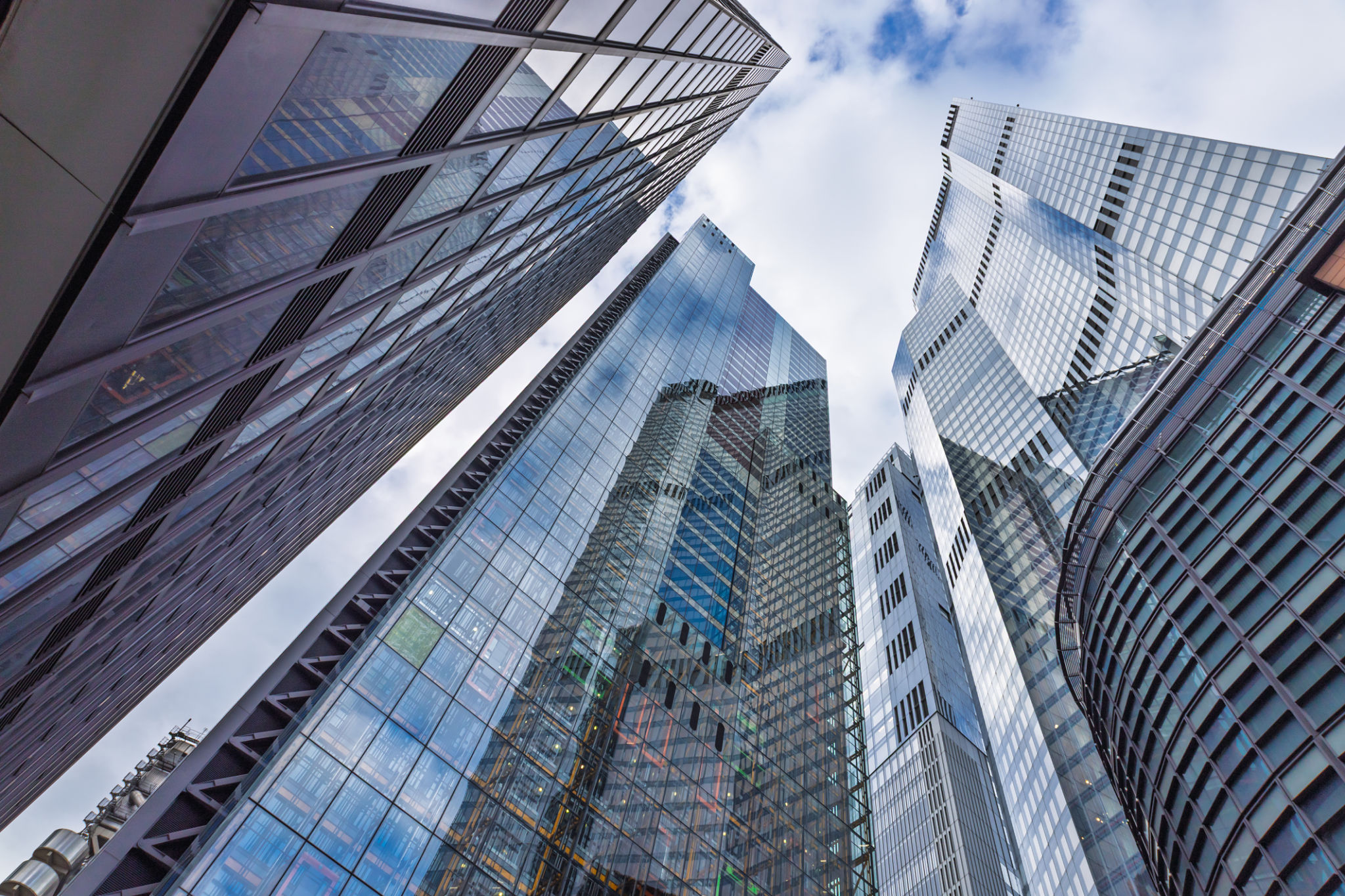Tall Reflective Office Towers With Glass Facades Captured From Street Level Looking Up Tall Reflective Office Towers With Glass Facades Captured From Street Level Looking Up