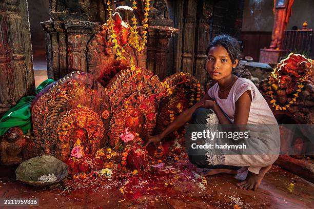 young girl praying in an ancient temple in bhaktapur, nepal - kathmandu stock pictures, royalty-free photos & images