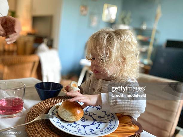 toddler girl having easter breakfast. - easter breakfast stock pictures, royalty-free photos & images