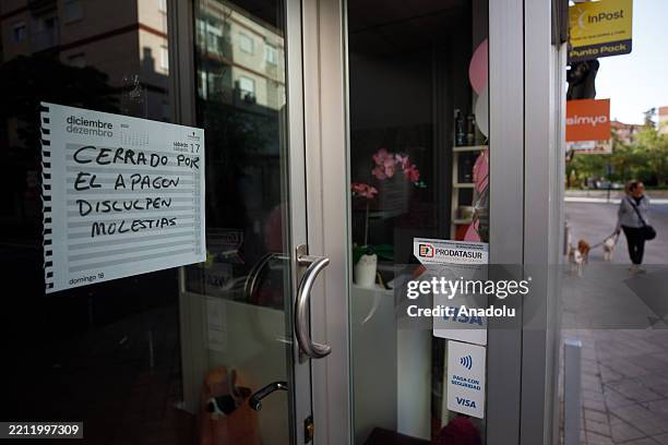 Paper hung on a business door says " Closed due to the blackout" as a widespread power outage strikes Spain and Portugal in Granada, Spain on April...