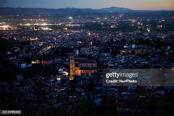 General view of the city of Granada, with the Alhambra, is plunged into darkness during the power outage that affects Spain nationwide in Granada,...