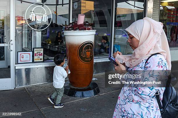Falls Church, VA A young boy drinks bubble tea at Eden Center in Falls Church, VA on April 18, 2025. Eden Center is the commercial and cultural hub...