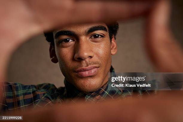 young man with cool attitude making finger frame - attitude stock pictures, royalty-free photos & images