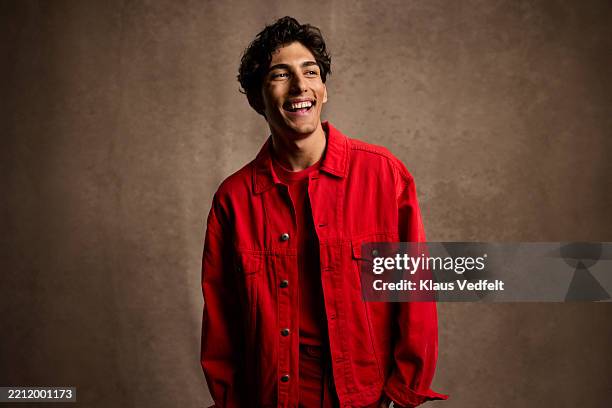 happy young man wearing red casuals looking away - white jacket stock pictures, royalty-free photos & images