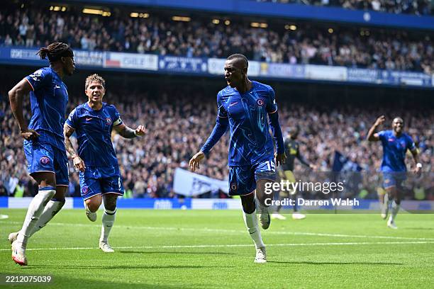 Nicolas Jackson of Chelsea celebrates scoring his team's first goal with teammates Noni Madueke and Enzo Fernandez during the Premier League match...