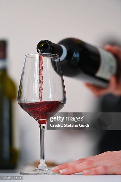 Close-up of Sommelier pours wine into a glass during the Vinum Alba 2025 on April 26, 2025 in Alba, Italy. Vinum Alba is an international wine fair...
