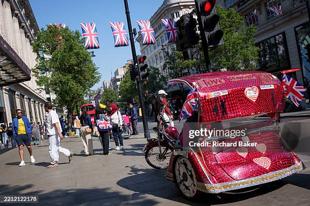 Pedicab waits for the next fare outside Selfridges on Oxford Street, on 29th April 2025, in London, England.