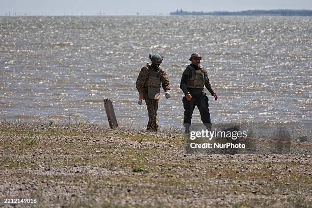 Ukrainian Navy servicemen work to dispose of a FAB-500 aerial bomb that is retrieved from the Black Sea in the Odesa region, Ukraine, on April 29,...