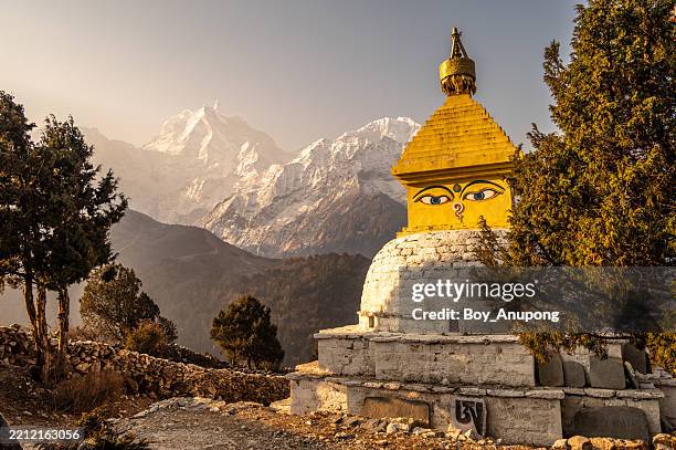tibetan buddhist stupa in pangboche village of nepal with mt.kangtega (6,779 m) and mt.thamserku (6,608 m) in the background. - nepal culture stock pictures, royalty-free photos & images
