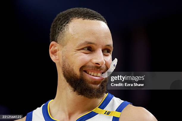 Stephen Curry of the Golden State Warriors smiles while chewing on his mouthguard during the third quarter in Game Three of the Western Conference...