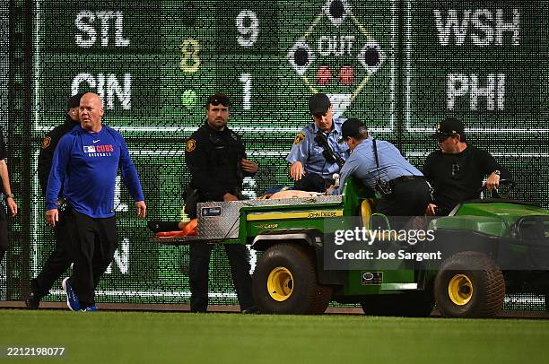 Fan is carted off the field after falling from the stands during the seventh inning of the game between the Chicago Cubs and the Pittsburgh Pirates...