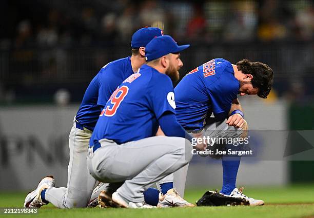 Dansby Swanson and Michael Busch of the Chicago Cubs look on after a fan fell from the stands during the seventh inning against the Pittsburgh...