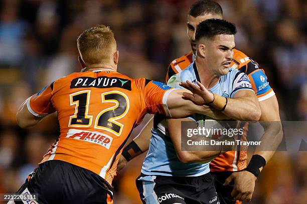 Daniel Atkinson of the Sharks is tackled during the round eight NRL match between Wests Tigers and Cronulla Sharks at Leichhardt Oval, on April 27 in...