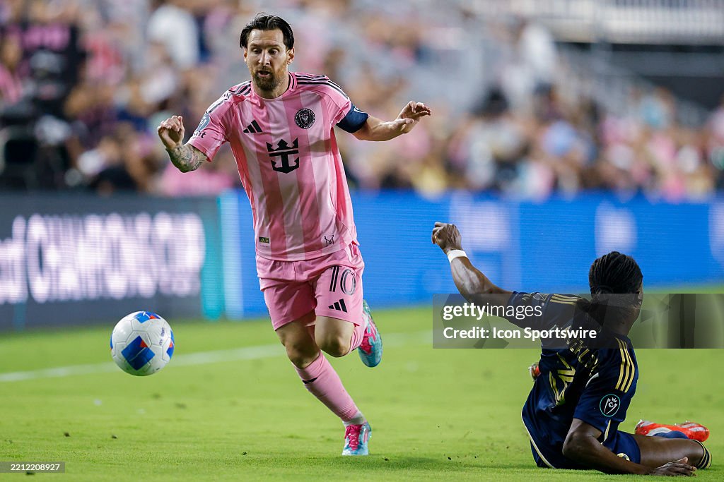 Samuel Basabe Lionel Messi of Inter Miami CF dribbles the ball past Samuel Adekugbe ...