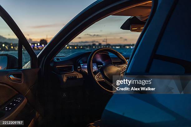 modern car interior at sunset with coastal view. - cuadro de instrumentos fotografías e imágenes de stock