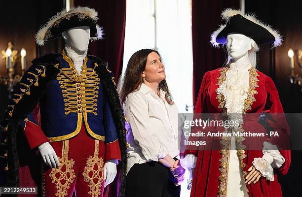 ZEMBARGOED TO 0001 FRIDAY MAY 2 National Trust Curator Alice Strickland looks at dresses and costumes designed by students from Wimbledon College of...