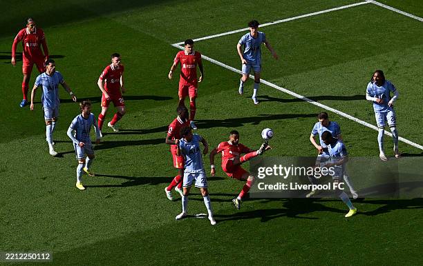 General view as Cody Gakpo of Liverpool shoots under pressure from Brennan Johnson of Tottenham Hotspur during the Premier League match between...