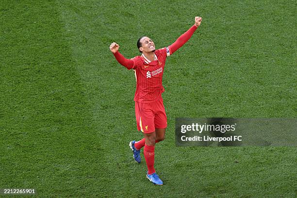 Virgil van Dijk of Liverpool celebrates the teams victory and confirmation of winning the Premier League title after the Premier League match between...