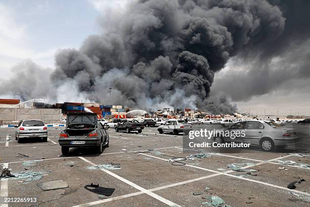 Heavy smoke rises at the scene of an explosion that took place a day earlier at the Shahid Rajaee port dock, southwest of Bandar Abbas in the Iranian...