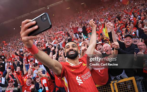 Mohamed Salah of Liverpool takes a selfie with the fans, as they celebrate the teams victory and confirmation of winning the Premier League title...
