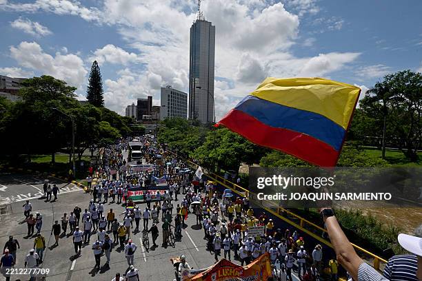 Man waves a Colombian national flag during a May Day demonstration, marking International Workers' Day, in Cali, Colombia, on May 1, 2025.