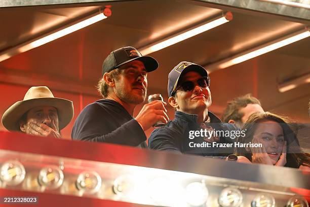 Luke Wilson, Ashton Kutcher and Mila Kunis are seen onstage with Midland at the T-Mobile Mane Stage during the 2025 Stagecoach Festival on April 27,...