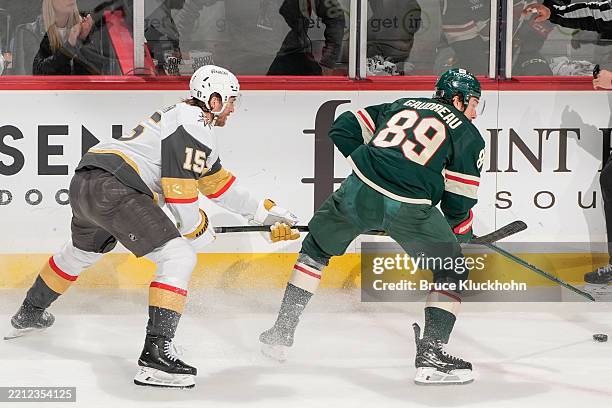 Frederick Gaudreau of the Minnesota Wild handles the puck with Noah Hanifin of the Vegas Golden Knights defending during Game Six of the First Round...