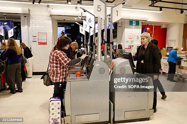 Customers use self service checkouts at a Coles supermarket. Melbourne, the capital of Victoria, Australia, is renowned for its rich arts and...