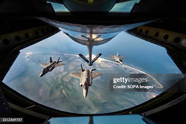 Fighter jets of the Royal Netherlands Air Force in formation above the Wadden Sea. The 100th Air Refuelling Group commemorates Operation Chowhound ....