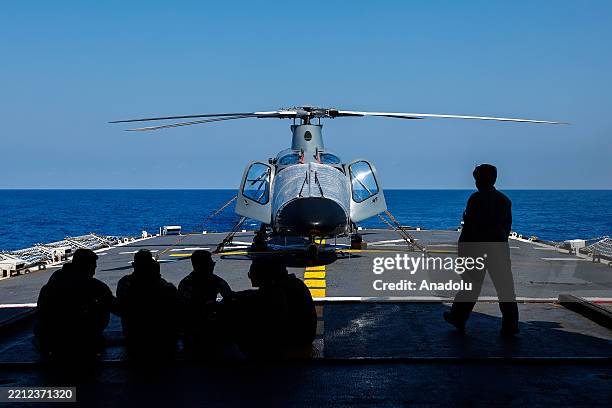 Filipino navy officers chat on the flight desk of the Philippine Navy warship, in West Philippine Sea, Philippines, on April 28, 2025. Aboard the...